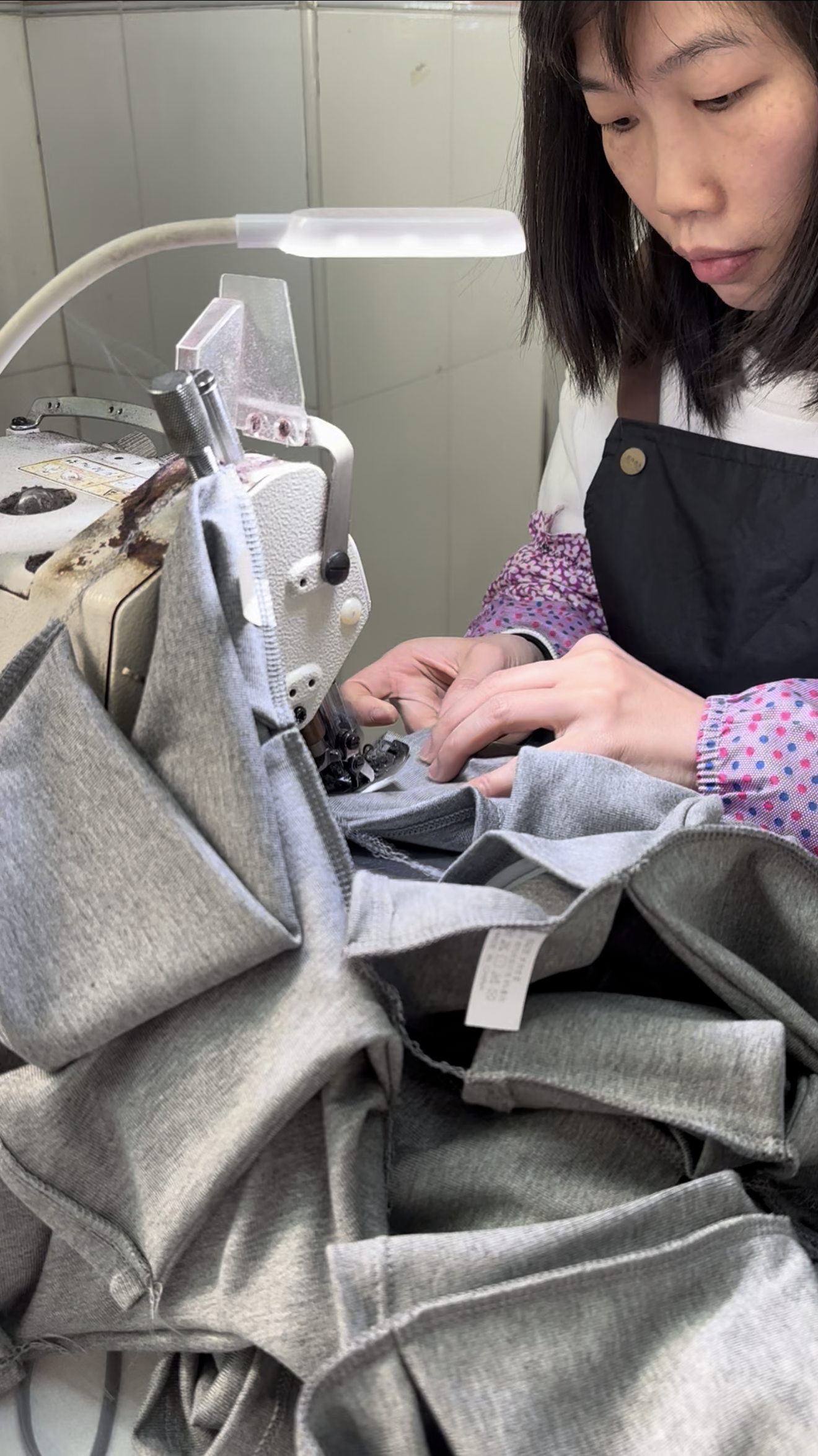 Operator sewing a garment at GJ